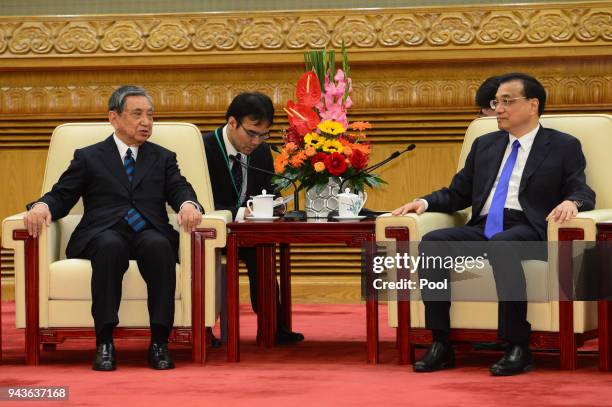 Yohei Kono, head of the Japanese Association for the Promotion of International Trade talks to Chinese Premier Li Keqiang during their meeting at the...
