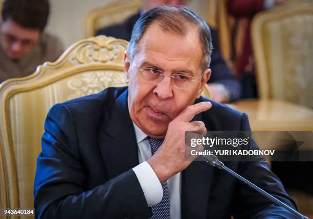 Russian Foreign Minister Sergei Lavrov speaks with his Tajik counterpart during their meeting in Moscow on April 9, 2018.