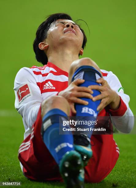 Tatsuya Ito of Hamburg lays injured during the Bundesliga match between Hamburger SV and FC Schalke 04 at Volksparkstadion on April 7, 2018 in...