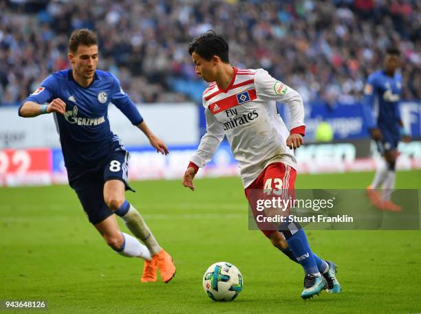 Tatsuya Ito of Hamburg is challenged by Leon Goretzka of Schalke during the Bundesliga match between Hamburger SV and FC Schalke 04 at...