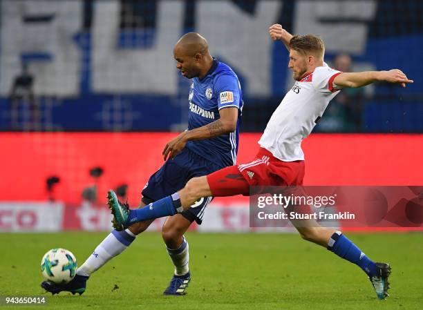 Aaron Hunt of Hamburg is challenged by Naldo of Schalke during the Bundesliga match between Hamburger SV and FC Schalke 04 at Volksparkstadion on...