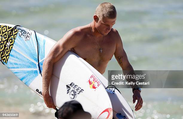 Mick Fanning of Australia walks to the beach marshall to collect his contest jersey before his Round 4 heat of the Billabong Pipeline Masters on...