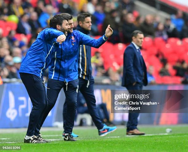 Lincoln City manager Danny Cowley, left, and Lincoln City's assistant manager Nicky Cowley, shouts instructions to their team from the technical area...