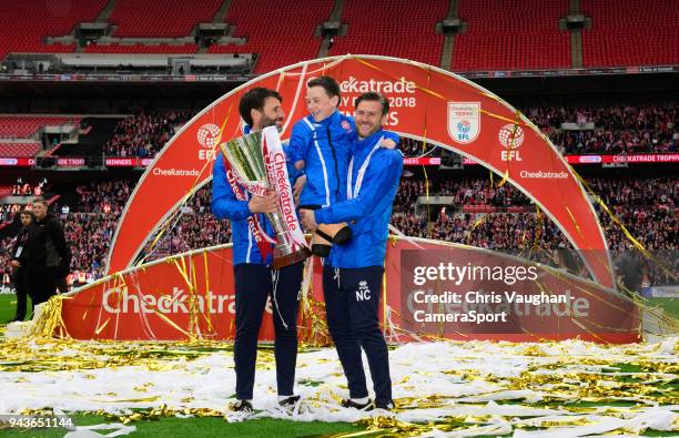 Lincoln City manager Danny Cowley, left, Harvey Phillips, centre, and Lincoln City's assistant manager Nicky Cowley pose for photographs with the EFL...