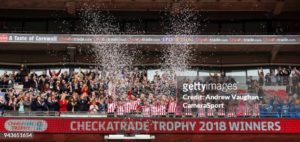Lincoln City's Luke Waterfall lifts the EFL Checkatrade Trophy into the air following the Checkatrade Trophy Final match between Lincoln City and...