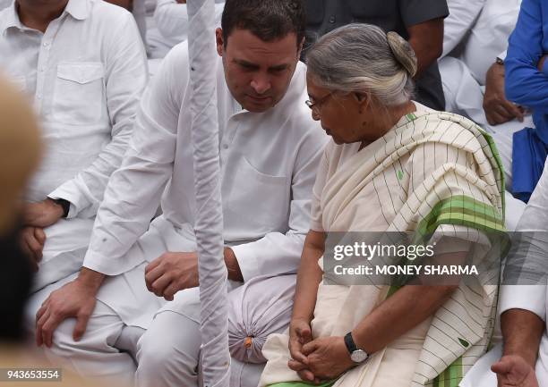 Indian National Congress party president Rahul Gandhi , talks with Sheila Dixit, former Chief Minister of Delhi as he observes a fast outside Raj...