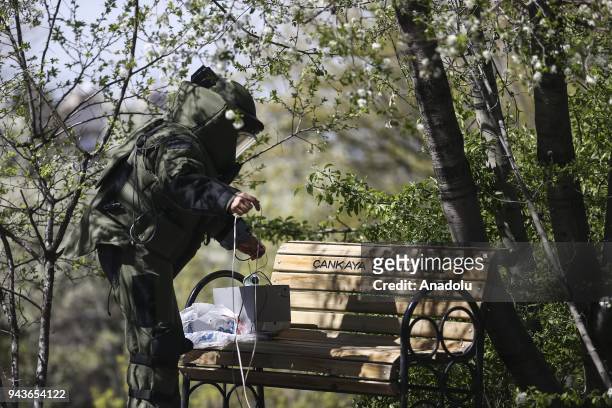 An explosive Ordnance Disposal Technician of Bomb Disposal and Investigations Division prepares to inspect a suspicious package with a detonator in...