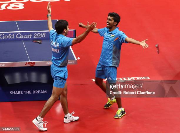 Harmeet Desai and Sathiyan Gnanasekaran of India celebrate after winning the gold medal during the Men's Team Table Tennis Gold Medal Match on day...