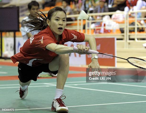 Malaysia's Wong Mew Choo reaches for a return against Adriyanti Firdasari of Indonesia in their women's singles match of the women's team badminton...