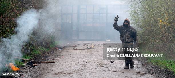 Protestor gestures during clashes with riot police in "Les Fosses Noires" in the ZAD in Notre-Dame-des-Landes, western France, on April 9, 2018. -...