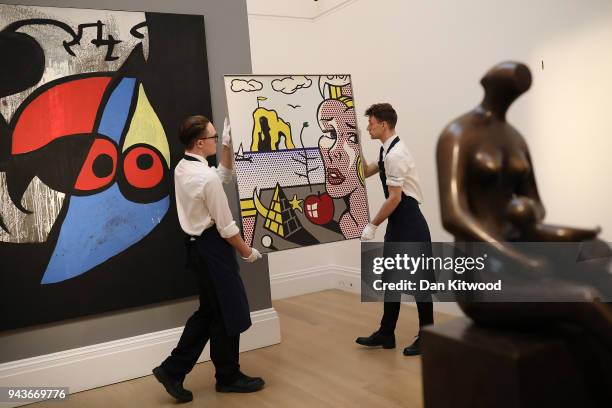 Sotheby's employees pose with a painting entitled 'Still Life with Head' by Roy Lichtenstein during a UK preview of the 'Impressionist and Modern...