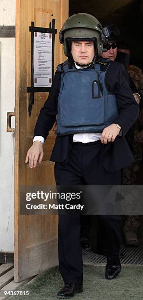 Prime Minister Gordon Brown wears a helmet and body armour as he leaves 'Little Heathrow' at Kandahar Airbase on December 13, 2009 in Kandahar,...