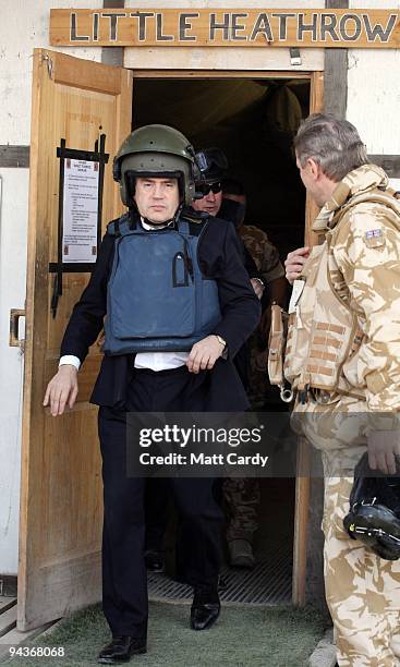 Prime Minister Gordon Brown wears a helmet and body armour as he leaves 'Little Heathrow' at Kandahar Airbase on December 13, 2009 in Kandahar,...