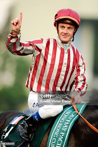 Olivier Peslier from France riding Vision D'etat celebrates after winning celebrates after winning the Cathay Pacific Hong Kong Cup race 8 during the...