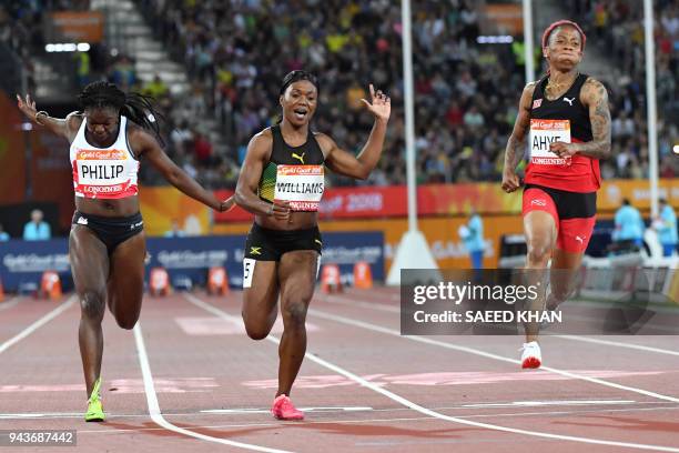 England's Asha Philip, Jamaica's Christania Williams, Trinidad and Tobago's Michelle-Lee Ahye cross the finish line in the athletics women's 100m...