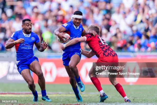 Tomasi Alosio of Samoa receives a tackle from Phil Jones of Wales during the HSBC Hong Kong Sevens 2018 Shield Final match between Samoa and Wales on...