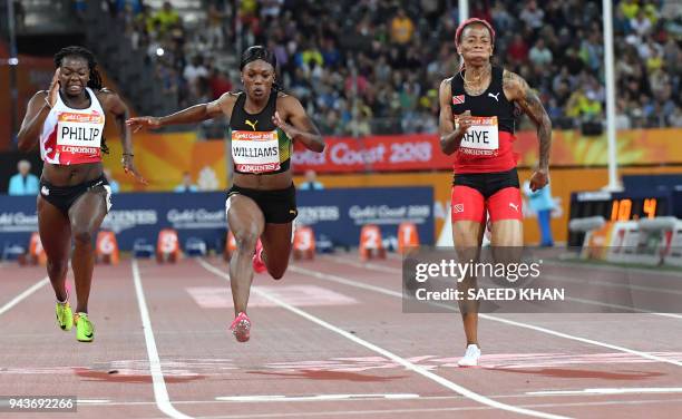 England's Asha Philip, Jamaica's Christania Williams, Trinidad and Tobago's Michelle-Lee Ahye cross the finish line in the athletics women's 100m...