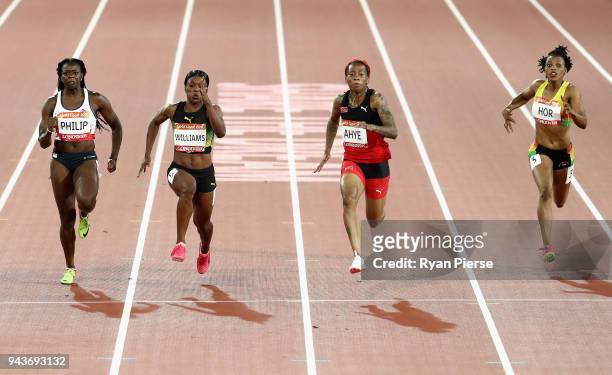 Asha Philip of England, Christania Williams of Jamaica, Michelle-Lee Ahye of Trinidad and Tobago and Halutie Hor of Ghana compete in the Womens 100...