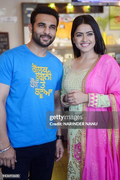 Indian actor Harish Verma and actress Simmi Chahal pose during a promotional event for the upcoming Punjabi film "Golak Bugni Bank Te Batue" in...