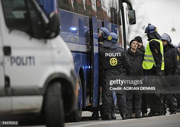 Protestors are taken onto a bus by police officers during an impromptu demonstration in the northern part of Copenhagen on December 13, 2009. Several...