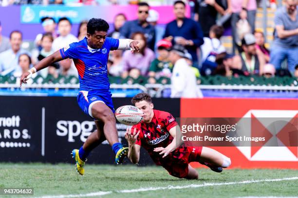 Laaloi Leilua of Samoa fights for the ball with Tomi Lewis of Wales during the HSBC Hong Kong Sevens 2018 Shield Final match between Samoa and Wales...