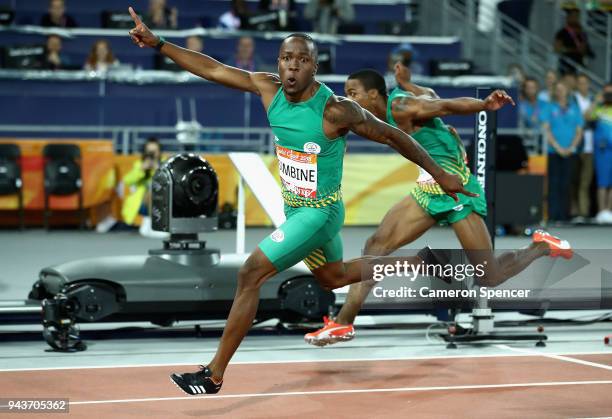 Akani Simbine of South Africa celebrates winning gold as he crosses the line ahead of silver medalist Henricho Bruintjies of South Africa in the...