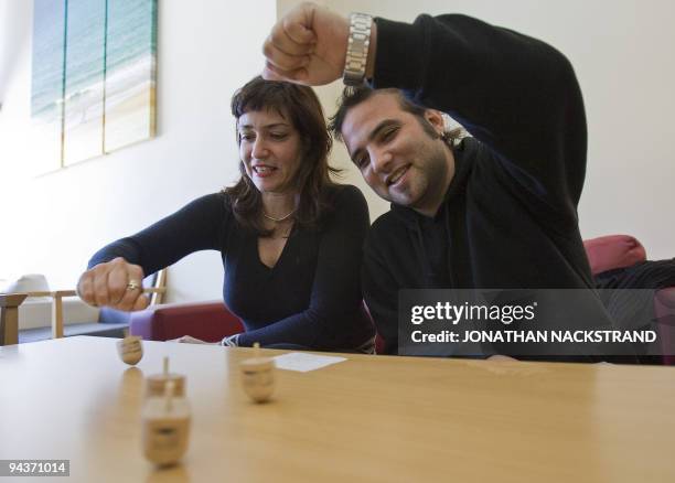 Israelis take part in a Dreidel competition during the Jewish festival of Hanukkah in Tel Aviv on December 13, 2009. A four-sided spinning top with a...