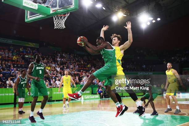 Abdul Yahaya of Nigeria is challenged by Angus Brandt of Australia during the Preliminary Basketball round match between Australia and Nigeria on day...