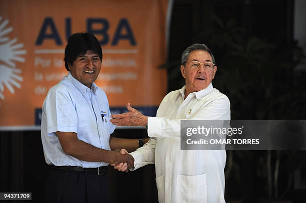 Bolivian President Evo Morales is greeted by Cuban President Raul Castro during the welcoming ceremony of the Bolivarian Alternative for the Americas...