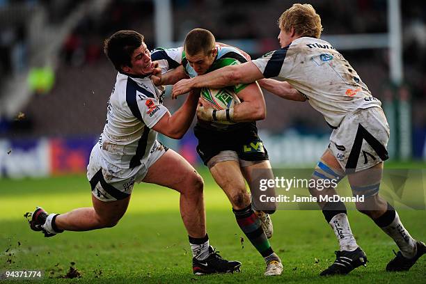 Mike Brown of Harlequins is tackled by Marc Jones and David Seymour of Sale Sharks during the Heineken Cup Pool Five match between Harlequins and...