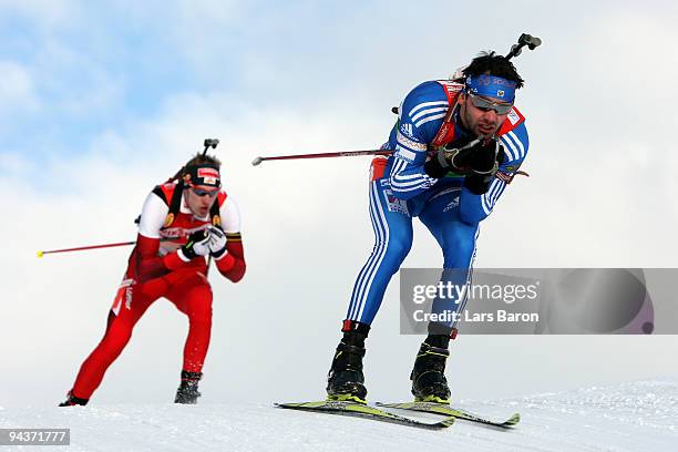 Nikolay Kruglov of Russia competes infront of Dominik Landertinger of Austria during the Men's 4x7,5 km Relay in the IBU Biathlon World Cup on...