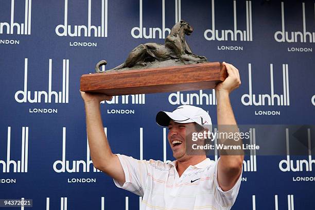 Pablo Martin of Spain celebrates with the trophy after winning the Alfred Dunhill Championship at Leopard Creek Country Club on a score of -17 on...