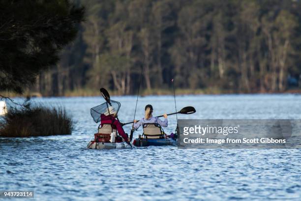 fishing by canoe - image by scott gibbons stock-fotos und bilder
