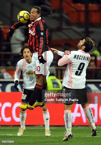 Ronaldinho of Milan and Antonio Nocerino of Palermo compete for the ball during the Serie A match between AC Milan and US Citta di Palermo at Stadio...