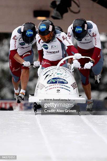 Pilot Janis Minins and his team members Daumants Dreiskens, Oskars Melbardis and Raivis Broks of Latvia compete in their first run of the four man...