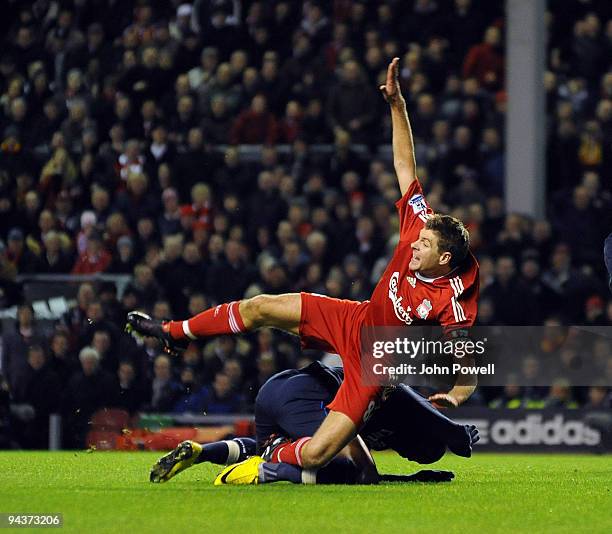 Steven Gerrard of Liverpool is brought down in the box by William Gallas of Arsenal during the Barclays Premier League match between Liverpool and...