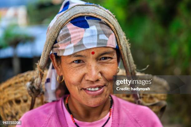 nepali woman carrying a basket near annapurna range - nepal women stock pictures, royalty-free photos & images