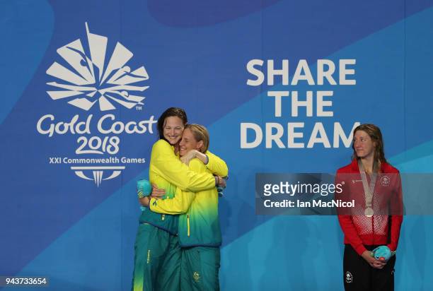 Cate and Bronte Campbell of Australia hug on the podium after winning gold and silver in the Women's 100m Freestyle final on day five of the Gold...