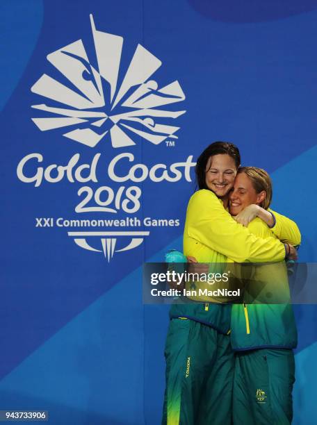 Cate and Bronte Campbell of Australia hug on the podium after winning gold and silver in the Women's 100m Freestyle final on day five of the Gold...