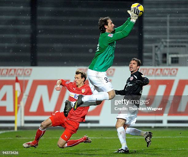 Goalkeeper Heinz Mueller and Zsolt Loew of Mainz battle for the ball with Julian Schieber of Stuttgart during the Bundesliga match between FSV Mainz...