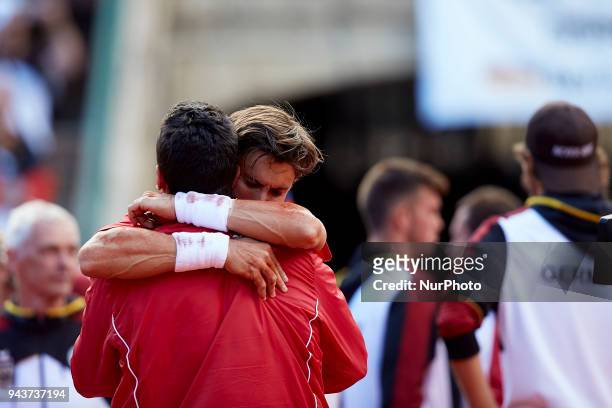 David Ferrer of Spain celebrates his victory in is match against Philipp Kohlschreiber of Germany with Sergi Bruguera Captain of Spain during day...