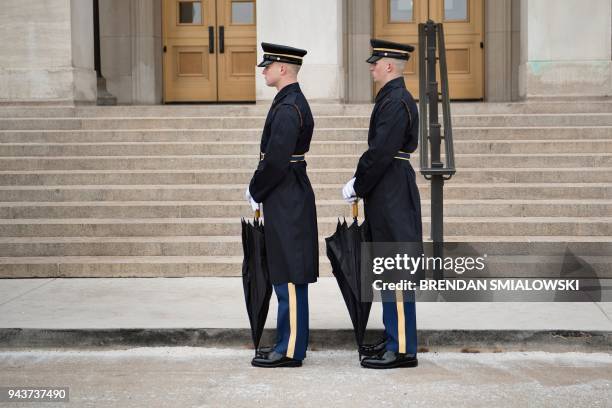 Members of the US military await an honor cordon with US Secretary of Defense James Mattis and Qatar's Emir Sheikh Tamim Bin Hamad Al-Thani at the...