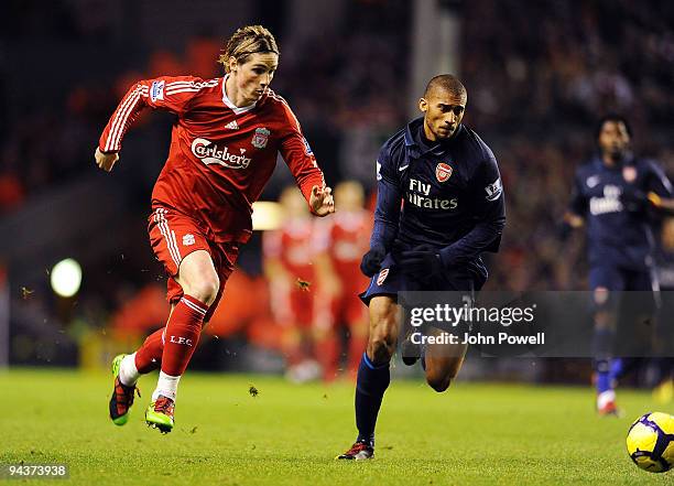Fernando Torres competes with Armand Traore of Arsenal during the Barclays Premier League match between Liverpool and Arsenal at Anfield on December...