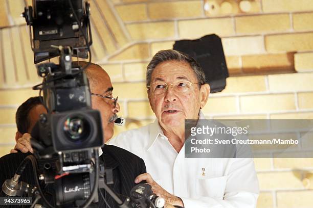 Cuba's President Raul Castro, brother of Revolution leader Fidel Castro, looks through the viewfinder of a TV camera during the welcome ceremony of...
