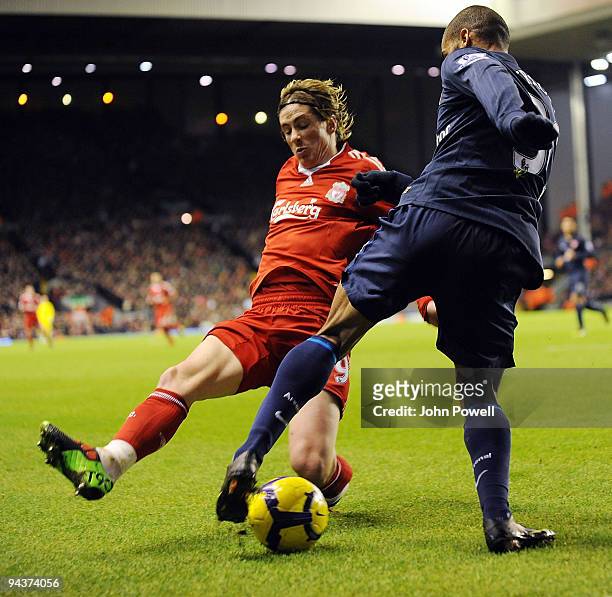 Fernando Torres of Liverpool competes with Armand Traore of Arsenal during the Barclays Premier League match between Liverpool and Arsenal at Anfield...