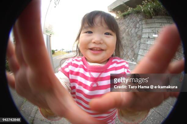 a girl looking at fish-eye lens camera in japan - fish eye photos et images de collection