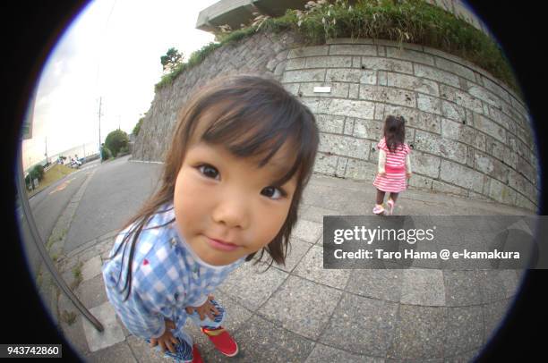 a girl looking at fish-eye lens camera in japan - fish eye lens stockfoto's en -beelden