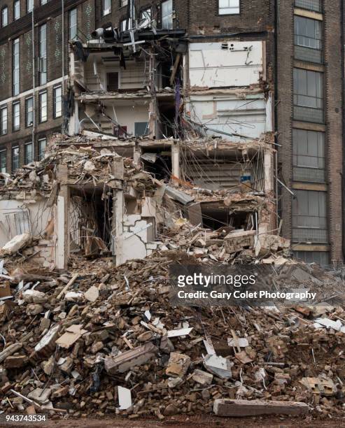 rubble piled up at base of partly demolished building - gary colet stock pictures, royalty-free photos & images
