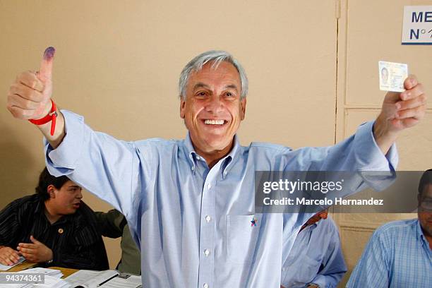 Chilean presidential candidate Sebastian Pinera of National Renewal opposition party poses after casting his ballot during the national elections on...