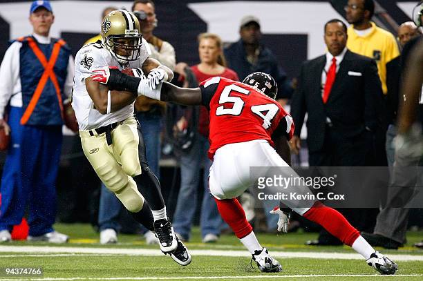 Running back Pierre Thomas of the New Orleans Saints runs with the ball in the first half against Stephen Nicholas of the Atlanta Falcons at Georgia...